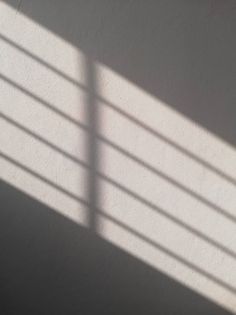 the shadow of a clock on a wall