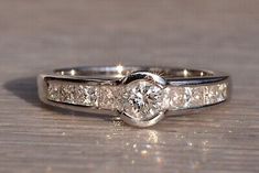 a couple of wedding rings sitting on top of a wooden table