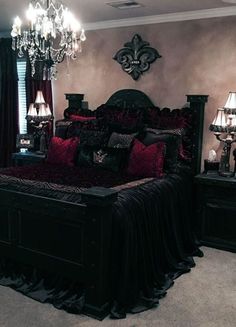 a bedroom with a bed, chandelier and two lamps