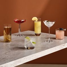 four different types of cocktails on a table