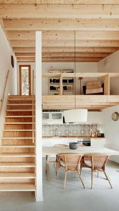 an open floor plan with stairs leading up to the kitchen and dining room area in this modern home