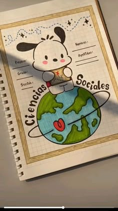 a notebook with an image of a dog on top of the globe and words written in spanish