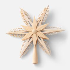 a wooden star ornament on a white background with an intricate design in the center