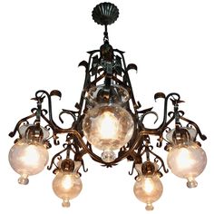 a chandelier with five lights hanging from it's center and four bulbs on each end