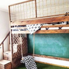 a room with a bunk bed and green carpeted flooring next to a blackboard