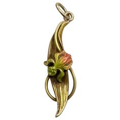 THIS IS A GORGEOUS AND RARE VICTORIAN - ART NOUVEAU PENDANT IN THE FORM OF A BEAUTIFUL PINK AND GREEN ENAMEL IRIS FLOWER IN 14 KARAT GOLD. THE IRIS FLOWER IS SET IN AN ELEGANT IRIS LEAF DESIGN WITH LOVELY ART NOUVEAU FLOWING NATURE INSPIRED LINES. THE PENDANT IS 14 KARAT YELLOW GOLD. THIS IS ONE OF THE MOST BEAUTIFUL ENAMEL FLOWER JEWELS WE HAVE SEEN. THE FLOWER IS BEAUTIFULLY RENDERED WITH GREAT DETAIL IN THE ENAMEL WORK ON EACH PETAL. THE PETALS AND LEAVES HAVE WONDERFUL NATURALISTIC FORM. THE PENDANT IS SO FULL OF ROMANCE AND THE DELIGHTS OF NATURE. THE PENDANT DATES TO CIRCA 1860-1910 The pendant is 1 1/4 inches (35m) long including the bales. It is 1 1/8 inches (28mm) long without the bales. The pendant is 3/8 inch (9mm) wide. The pendant is 14 Karat Gold. The pendant weighs 1.5 grams Art Nouveau Iris, Art Nouveau Necklaces, Art Nouveau Pendant, Iris Flower, Iris Flowers, Victorian Art, Enamel Flower, Green Enamel, Gorgeous Jewelry