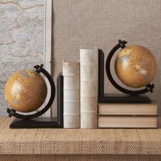 two books and a globe on a shelf