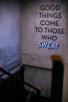 a sign that says good things come to those who sweat on the wall