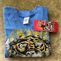 Ed Hardy Long Sleeve Tee Kids Boys Size 4/5 Very Nice Thermal Style Blue Winter Playwear Tops, Blue Winter Tops For Playwear, Blue Tops For Playwear In Winter, Unisex Blue Graphic Print Top, Unisex Blue Top With Graphic Print, Unisex Blue Tops With Graphic Print, Blue Graphic Print Unisex Top, Blue Graphic Print Tops For Playwear, Ed Hardy Long Sleeve