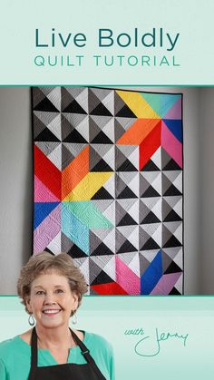 a woman standing in front of a quilt with the title live boldly quilting