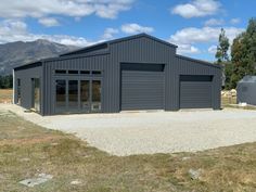 an industrial building with two garages in the background