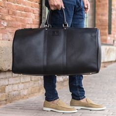 Heavy hardware and durable leather straps make our Duffle Bag durable and suitable for all your travel... whether on vacation or simply heading to the office. Designed to be as spacious and long-lasting as you need. Its dimensions are 24 x 12.6 x 11.4 inches / 61 x 32 x 29 cm (width x height x depth) THE DETAILS: Materials: black full grain italian calf leather + black box Italian calf leather + red box italian leather shoulder strap lining: Dark Brown Fabric THE FINE PRINT: Production timeline/ Dark Brown Fabric, Black Duffle Bag, Clothing Wardrobe, Print Production, Leather Duffle, Fabric Accessories, Fine Print, Loafer Sneakers, Brown Fabric