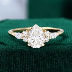 an oval cut diamond ring with three smaller round diamonds on the band, set in yellow gold