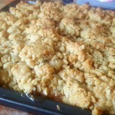 a close up of a tray of food with crumbs on the top and bottom