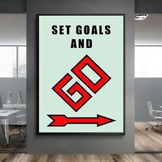 a poster with the words set goals and go on it in an empty room next to chairs