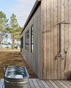 a hot tub sitting on top of a wooden deck next to a building with windows