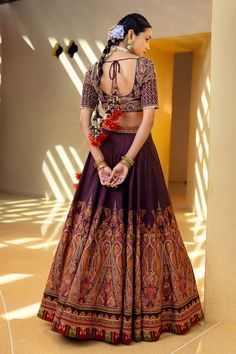 Wine lehenga with embroidered pattern, side zipper and gathered detailing. Paired with U-back blouse with tassel tie-up. Comes with a orange dupatta.
Component: 3
Pattern: Embroidered
Neckline: V-neck
Sleeve Type: Half sleeves
Fabric: Blouse and lehenga skirt: Natural silk, Dupatta: Organza
Color: Purple
Other Details: 
Gathered detailing
Tassel tie-up back
Note: The necklaces worn by the model and the outfit worn by the other male model are not for sale.
Occasion: Wedding - Aza Fashions Wine Lehenga, Orange Dupatta, Embroidered Bridal Lehenga, Lehenga Skirt, Embroidered Lehenga, Sleeves Blouse, Bridal Lehengas, Purple Blouse, Embroidered Neckline