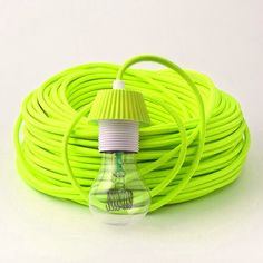 an electric light bulb is plugged into a green cord