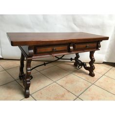 a wooden table with two drawers on it