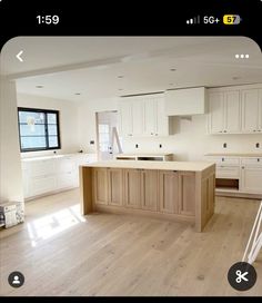 an image of a kitchen being remodeled with white cabinets and wood flooring in the background