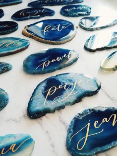 blue agate with gold lettering on it sitting on top of a white tablecloth