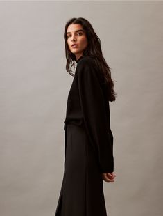 A modern style with unexpected detailing, this structured skirt is crafted with stretch for added flexibility. Cut with a clean finish high-waist silhouette and a single vent at the front.  Material: 66% Polyester, 29% Viscose, 5% Elastane. Luxury Black Relaxed Skirt, Luxury Black Stretch Maxi Skirt, Black Voluminous Gathered Skirt, Black A-line Voluminous Skirt, Black A-line Voluminous Maxi Skirt, Stretches For Flexibility, Stretch Skirt, Calvin Klein, High Waisted