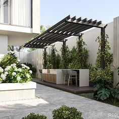 an outdoor patio with white flowers and greenery on the side of the building,