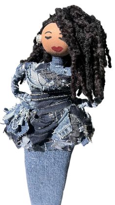 a doll made out of jeans and denim fabric with dreadlocks on it's head