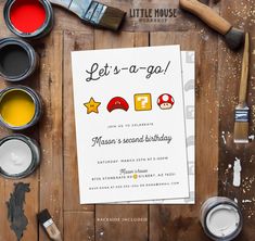 a birthday party with paint, brushes and paints on the table next to it is a poster that says let't - a - go