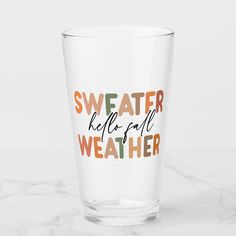 a shot glass with the words sweater be prepared weather printed on it, sitting on a marble surface