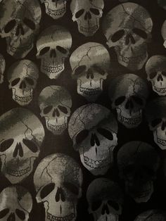 a bunch of skulls that are all over the place with black and white colors on them