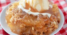 a piece of apple pie on a plate with ice cream and caramel drizzle