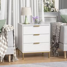 a living room scene with focus on the chest of drawers and chair in the foreground