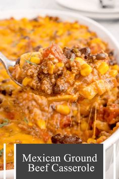 mexican ground beef casserole in a white dish with a spoon full of the casserole