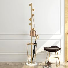 a pair of shoes and an umbrella stand in front of a white wall with a wooden floor