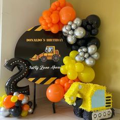 a construction themed birthday party with balloons and decorations