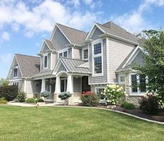 a large house with lots of windows and landscaping