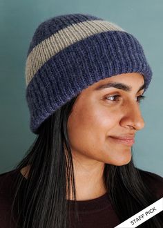 a woman wearing a blue and white striped hat