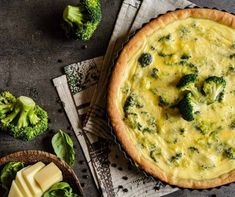 a quiche with broccoli and cheese in a pie pan on a table