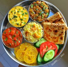 a metal plate topped with different types of food