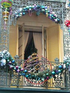 a balcony decorated for christmas with ornaments and decorations