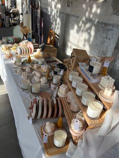 a table topped with lots of different types of food and candles on top of it