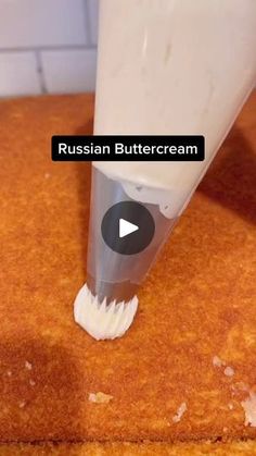 a toothbrush sticking out of the side of a piece of bread with russian buttercream on it