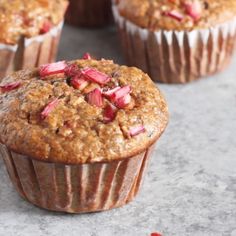 several muffins with crumbled toppings sitting on a table