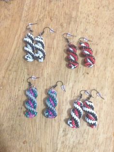 six pairs of earrings on a wooden table