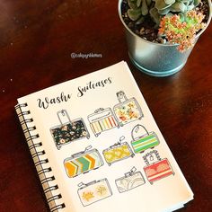 a notebook sitting on top of a wooden table next to a potted plant