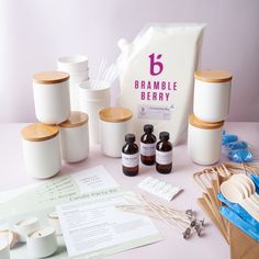 a table topped with lots of white containers and wooden spoons