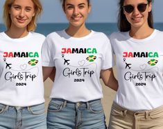 three girls wearing jamaica shirts on the beach