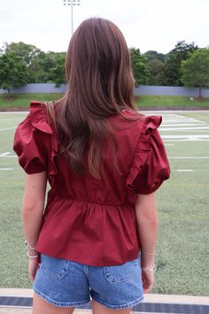 Elevate your wardrobe with our Maroon Peplum Ruffle Top! Made from high-quality poplin cotton, this top features puff sleeves and feminine ruffle details. With ties at each side, it offers a perfect fit. Whether for pre-fall or gameday, it's a must-have addition to your collection! Maroon peplum ruffle top Poplin cotton Puff sleeves Peplum hem Side ties Gameday top Maroon gameday top Cotton Ruffle Blouse For Brunch, Cotton Ruffles Blouse For Brunch, Fitted Cotton Puff Sleeve Top With Ruffles, Cotton Blouse With Gathered Sleeves For Brunch, Cotton Ruffle Puff Sleeve Blouse, Cotton Top With Ruffled Collar For Brunch, Cotton Puff Sleeve Top With Ruffle Hem, Cotton Puff Sleeve Blouse With Ruffles, Summer Balloon Sleeve Tops With Ruffle Hem