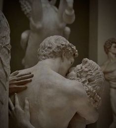 a statue of two men embracing each other